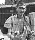 Image of a man behind camp wire