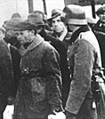 Image of German soldier and men in a ghetto